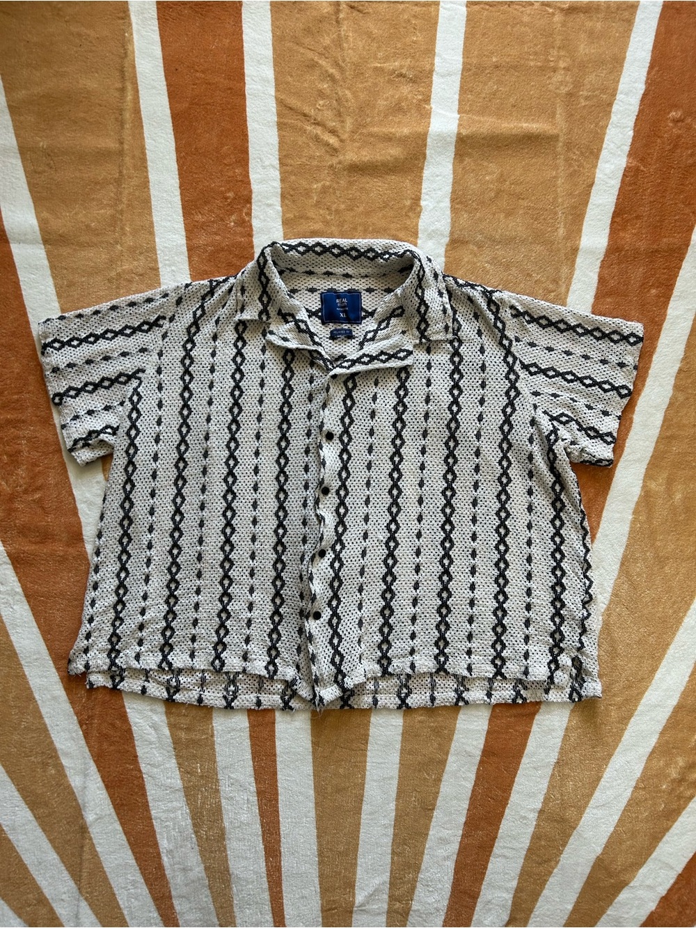 Knitted white button up shirt with brown stitching